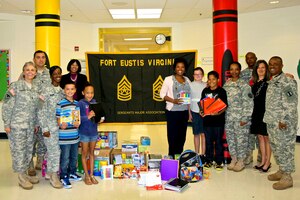 Members of the Fort Eustis Sergeants Major Association donate school supplies for students at the General Stanford Elementary School at Fort Eustis, Va., Sept. 10, 2013. The donation of the school supplies was the first official act of the recently-formed association, which was created to facilitate community outreach and address enlisted matters. (Courtesy photo/Released)