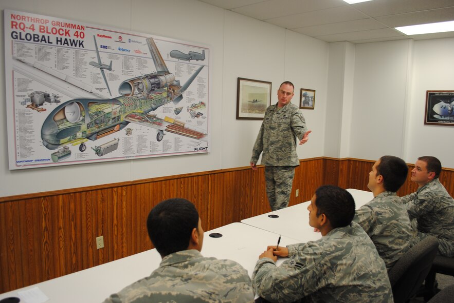 Staff Sgt. Kory Boardman from the 372nd Training Squadron, Detachment 27, asks a student to point out a specific part on the RQ-4 Block 40 Global Hawk diagram during a training session Sept. 9, 2013, on Grand Forks Air Force Base, N.D.  The field training detachment instructor was selected as the base’s Warrior of the Week for the third week of September 2013. (U.S. Air Force photo/Staff Sgt. Luis Loza Gutierrez) 
