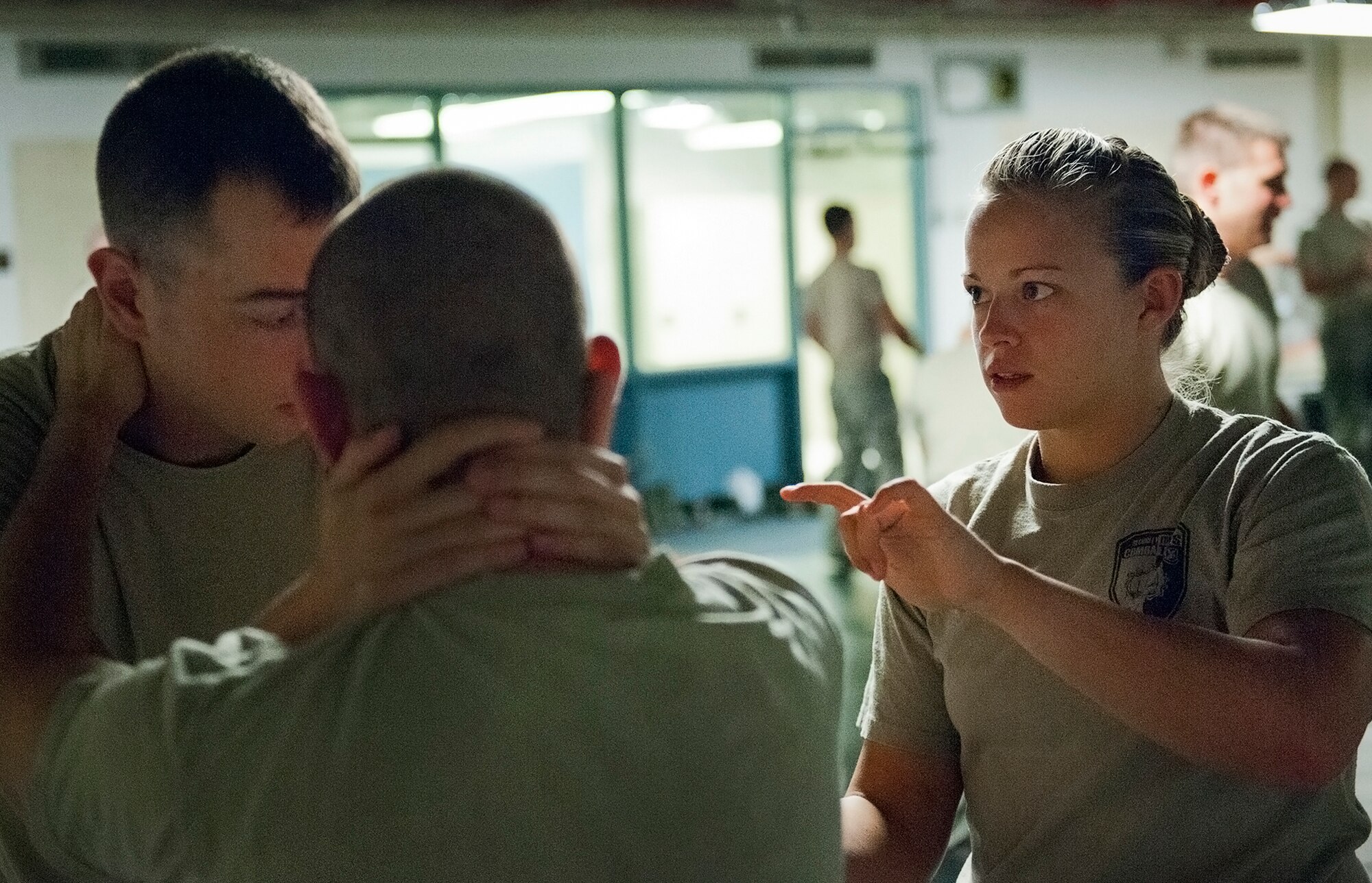 Senior instructor, Staff Sgt. Christy Sturdivant, of the 96th Ground Combat Training Squadron, ensures two Hurlburt Field security forces Airmen, use the proper technique during a day of training at the week-long combatives instructor course Sept. 12 at Eglin Air Force Base, Fla.  More than 25 Airmen from Eglin and Hurlburt Field completed the course earning their instructor certification.  The course was hosted by the 96th Ground Combat Training Squadron and taught by Sturdivant.  (U.S. Air Force photo/Samuel King Jr.) 