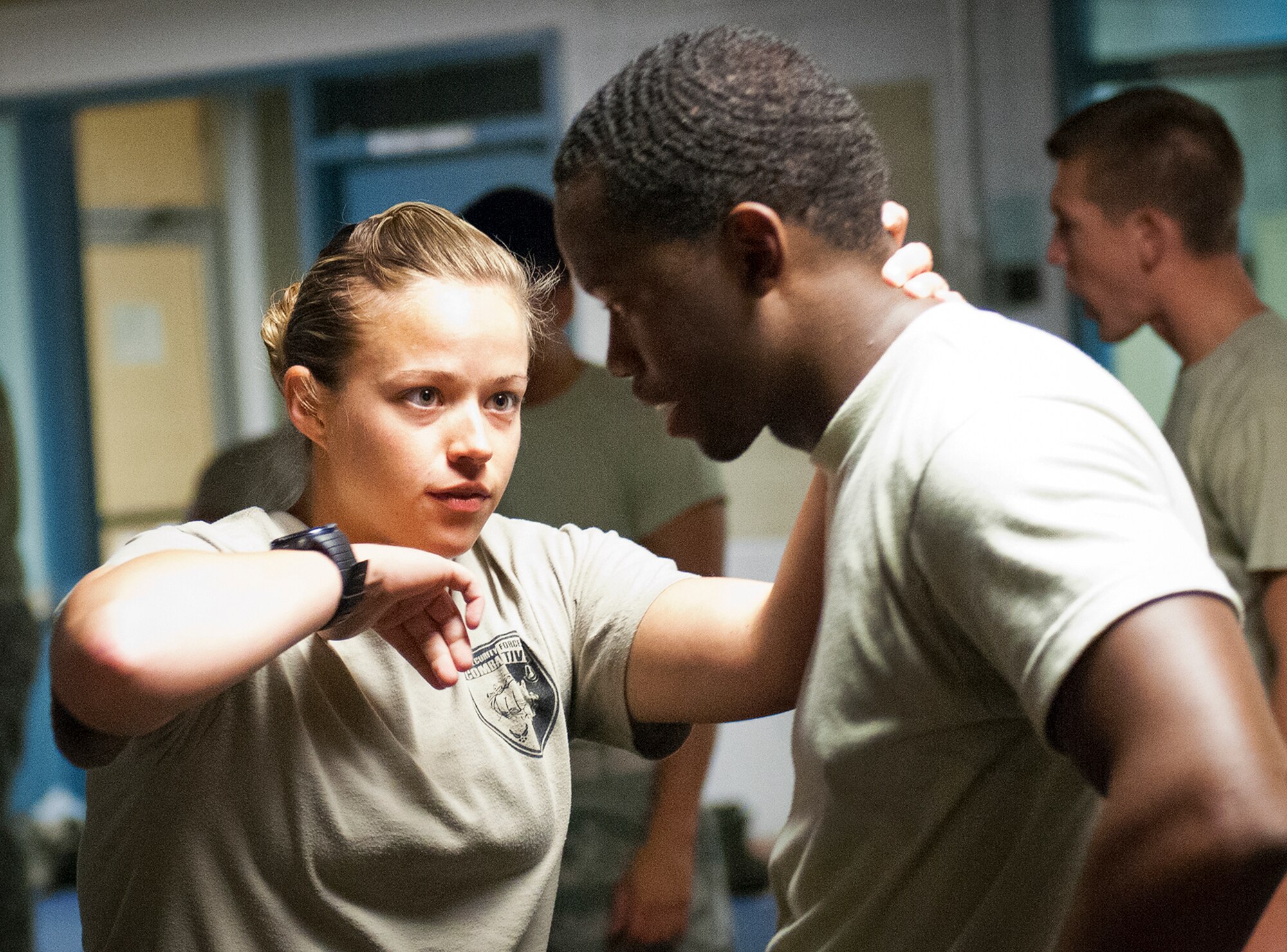 Senior instructor, Staff Sgt. Christy Sturdivant, of the 96th Ground Combat Training Squadron, shows Senior Airman Travis Parris, of the 96th Security Forces Squadron, a specific technique during a day of training at the week-long combatives instructor course Sept. 12 at Eglin Air Force Base, Fla.  More than 25 Airmen from Eglin and Hurlburt Field completed the course earning their instructor certification.  The course was hosted by the 96th Ground Combat Training Squadron and taught by Sturdivant.  (U.S. Air Force photo/Samuel King Jr.) 