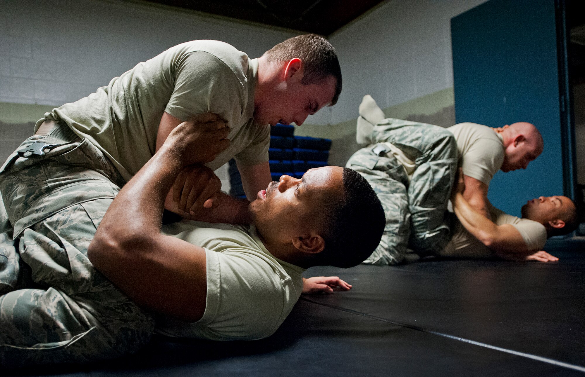 Staff Sgt. Erick Whiting and Airman 1st Class Eddie Smith, from the 96th Security Forces Squardon, grapple with each other during a day of training at the week-long combatives instructor course Sept. 12 at Eglin Air Force Base, Fla.  More than 25 Airmen from Eglin and Hurlburt Field completed the course earning their instructor certification.  The course was hosted by the 96th Ground Combat Training Squadron and taught by Staff Sgt. Christy Sturdivant.  (U.S. Air Force photo/Samuel King Jr.)
