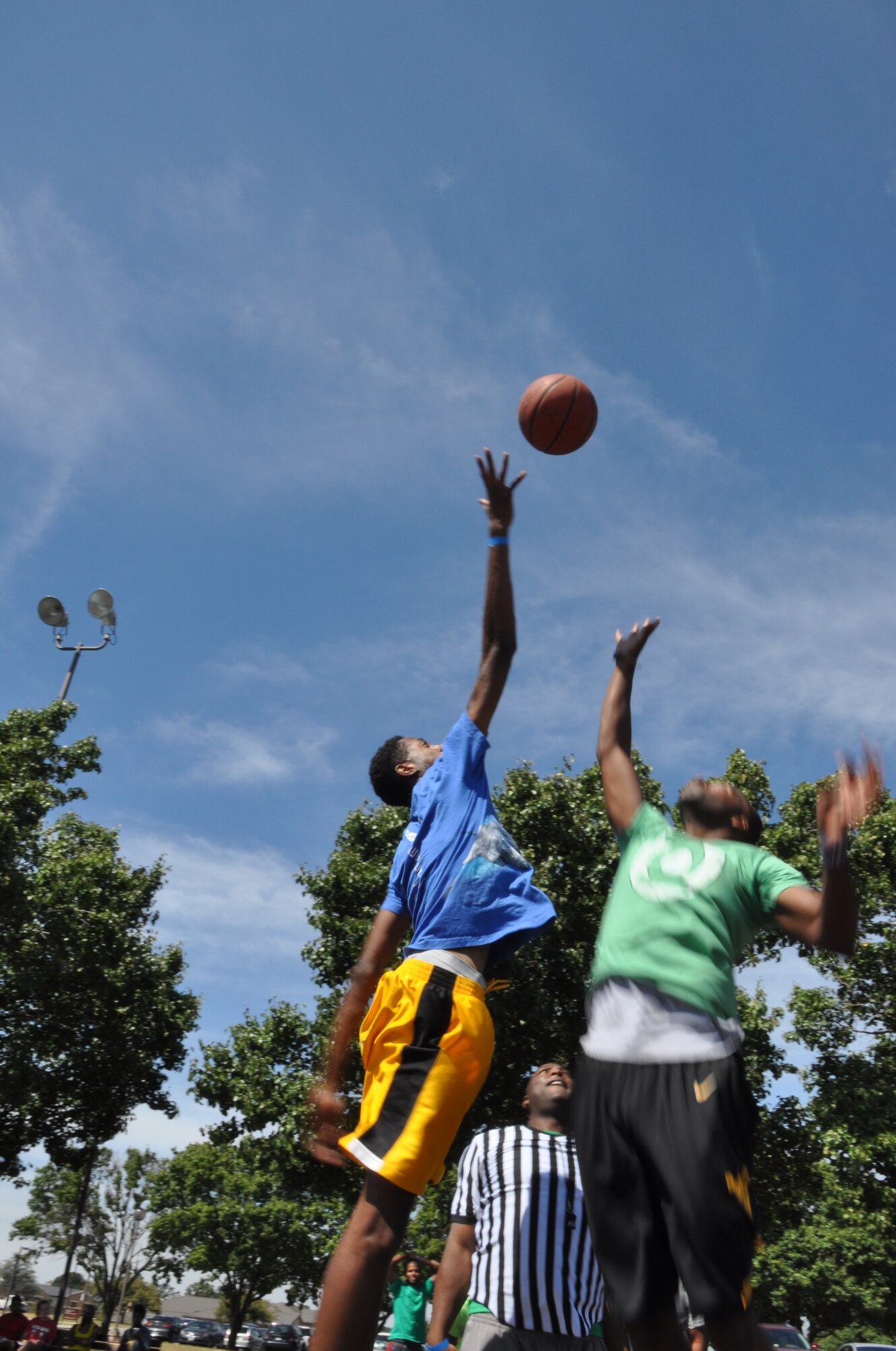 Members from the 459th Air Refueling Wing jump for a basketball during the wing’s sports and family day at Joint Base Andrews, Md., September 15, 2013. Basketball was one of the many sports at the wing’s family day event. (U.S. Air Force photo/ Staff Sgt. Katie Spencer) 