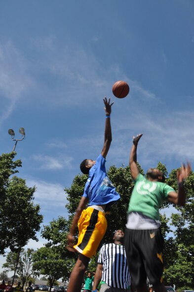 Members from the 459th Air Refueling Wing jump for a basketball during the wing’s sports and family day at Joint Base Andrews, Md., September 15, 2013. Basketball was one of the many sports at the wing’s family day event. (U.S. Air Force photo/ Staff Sgt. Katie Spencer) 