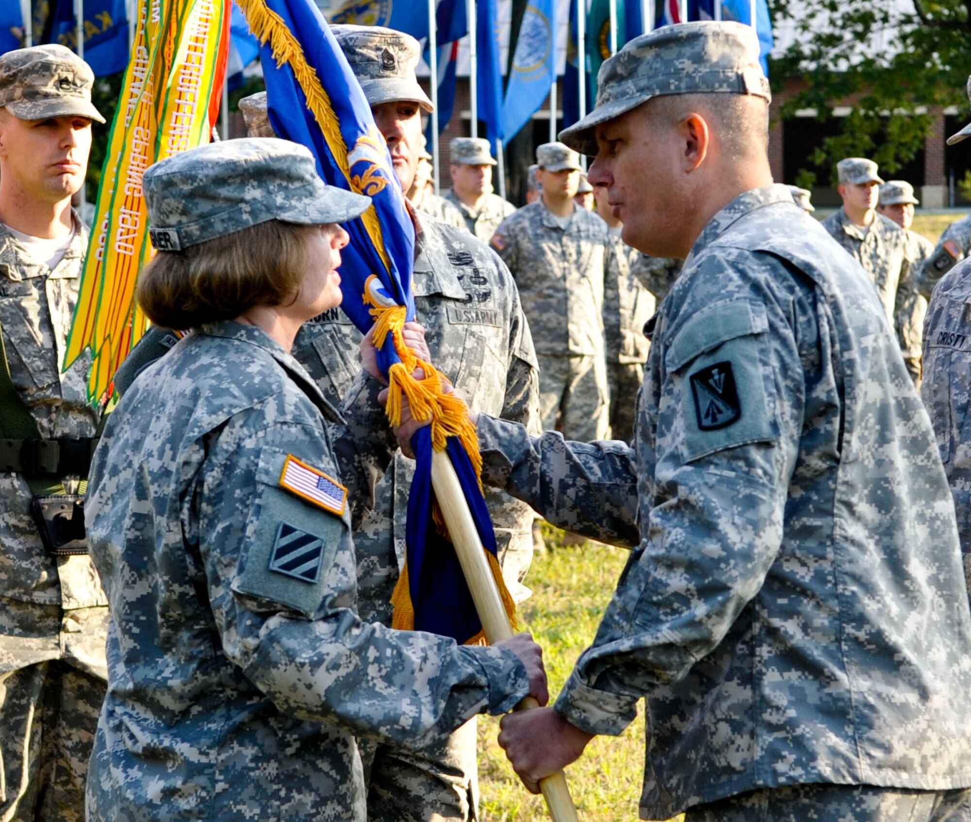 From left, U.S. Army Lt. Col. Heather Weigner, 2-210th Aviation Regiment commander, receives the unit colors from Col. Julius Rigole, 128th Aviation Brigade commander, during the unit’s change of command ceremony at Fort Eustis, Va., Sept. 12, 2013. Weigner assumed command of the unit from U.S. Army Lt. Col. William Cristy. The 210th Aviation Regiment works around the clock to improve the Army's aviation expertise, training Soldiers to maintain its fleet of helicopters using cutting-edge technologies (U.S. Air Force photo by Staff Sgt. Wesley Farnsworth / Released)