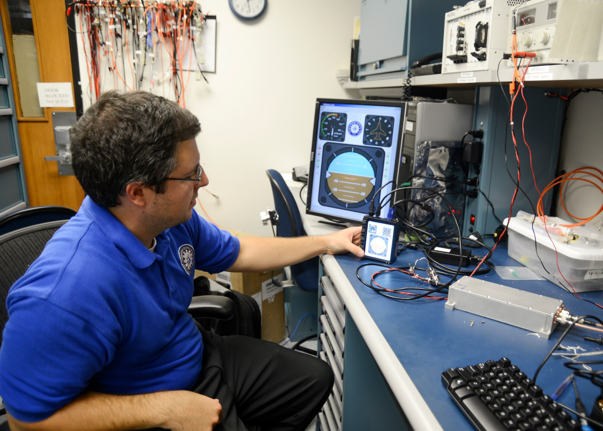 Air Force Instituute of Technology engineer Tom Pestak demonstrates the Control Monitoring and Debugging of SPACE JAM software used in the test aircraft. (U.S. Air Force photo by Rebecca Amber) 