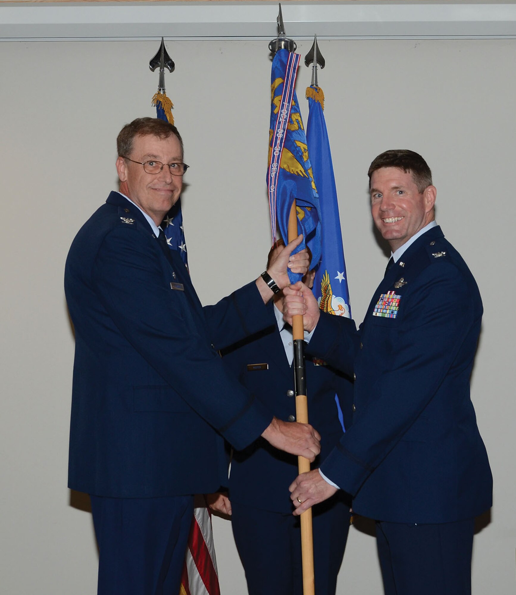WRIGHT-PATTERSON AIR FORCE BASE, Ohio - Col. Stephen D. Goeman, 445th Airlift Wing commander, passes the guidon to Col. David A. Owens, incoming 445th Operations Group commander, during an Appointment of Command ceremony Aug. 3. (U.S. Air Force photo/Tech. Sgt. Anthony Springer)