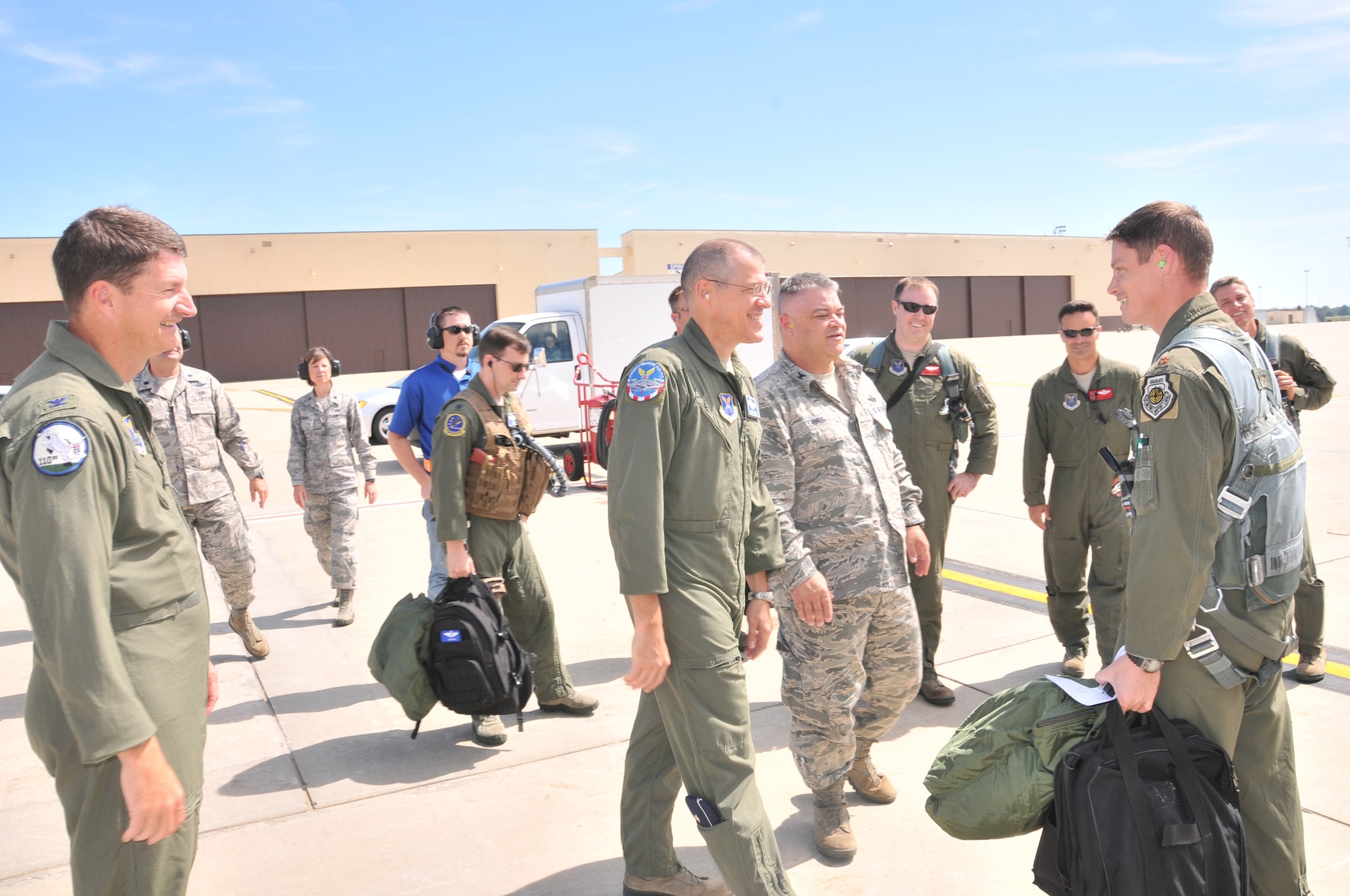 Brig Gen. Thomas Bussiere, 509th Bomb Wing commander (center) and Col Michael Francis, 131st Bomb Wing Missouri Air National Guard commander (far left) are among the 131st and 509th members gathered to meet Maj. Luke Jayne as he steps off the B-2  "Spirit of Alaska," Sept 14, 2013, at Whiteman AFB, Mo.  Jayne, who recently transferred from the 509th to the 131st, joins an elite group of 35 B-2 pilots who have achieved 1000 or more hours in the B-2 Stealth Bomber.  (U.S. Air National Guard Photo by Senior Master Sgt. Mary-Dale Amison/RELEASED)