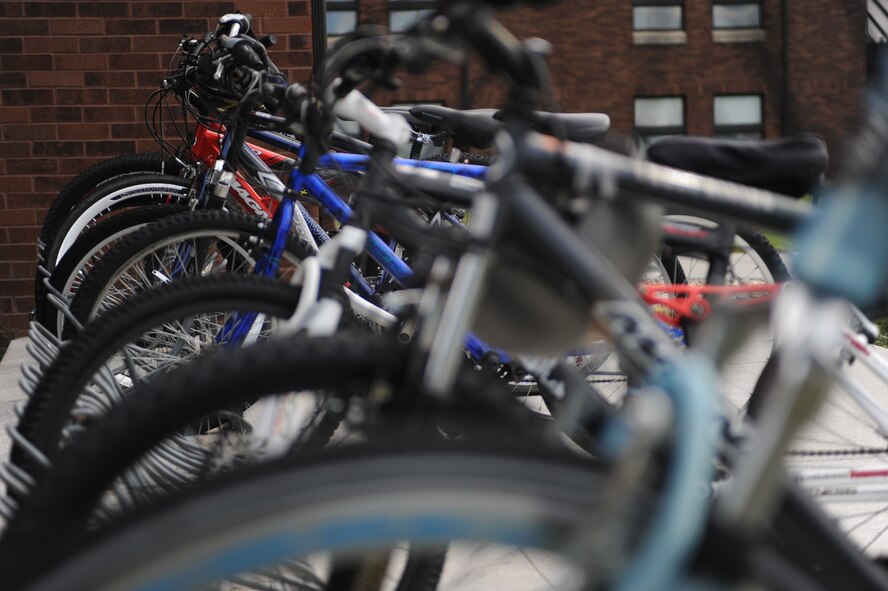 Bikes are secured outside the Borglum Hall dormitory at Ellsworth Air Force Base, S.D., Sept. 9, 2013. Airmen residing in the base dormitories are able to sign out and use one of 10 bicycles re-purposed under the Borrow-A-Bike program free of charge. (U.S. Air Force  photo by Senior Airman Yash Rojas/Released)