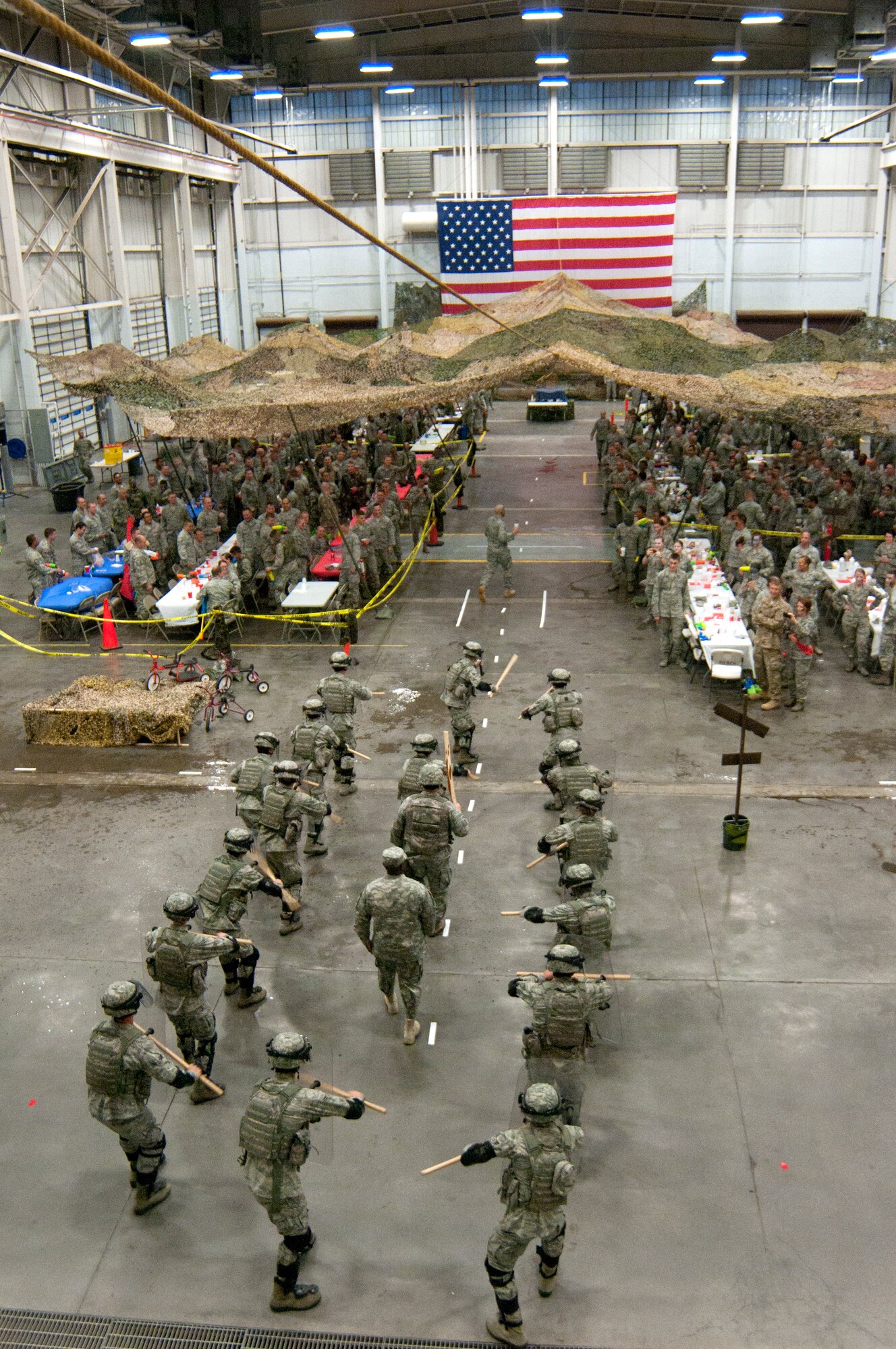 130913-F-BR137-099 Airmen from the 90th Missile Security Forces Squadron Flight 9 bang their shields with their batons as they escort the distinguished visitors – Chief Master Sgt. Michael Garrou, 90th Missile Wing command chief, and Command Sgt. Maj. Patrick Alston, U.S. Strategic Command senior enlisted leader – through the Airmen of the 90th Missile Wing to their table during the enlisted combat dining-in held in the Peacekeeper High bay, Bldg. 1501, F.E. Warren Air Force Base, Wyo., Sept. 13, 2013. (U.S. Air Force photo by Airman 1st Class Jason Wiese)