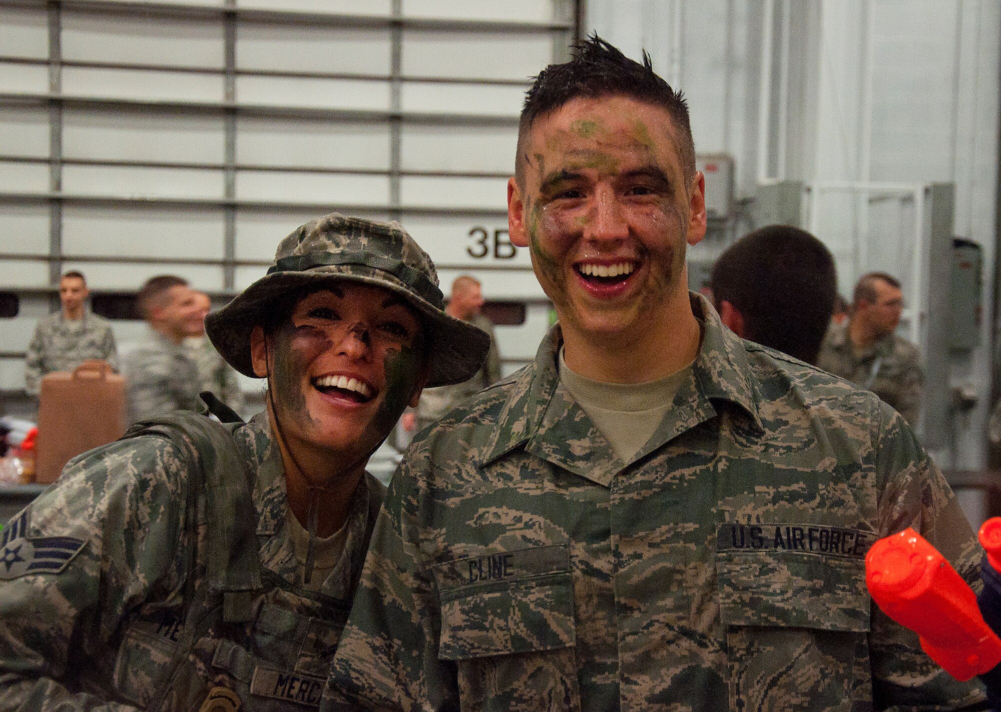 130913-F-GZ967-170 Senior Airman Audrina Mercado and Airman Calin Cline, 90th Comptroller Squadron, show the true meaning of an enlisted combat dining-in – building camaraderie between the enlisted personnel of F.E. Warren Air Force Base, Wyo., held in the Peacekeeper High Bay, Bldg. 1501, Sept. 13, 2013. (U.S. Air Force photo by Airman 1st Class Brandon Valle)