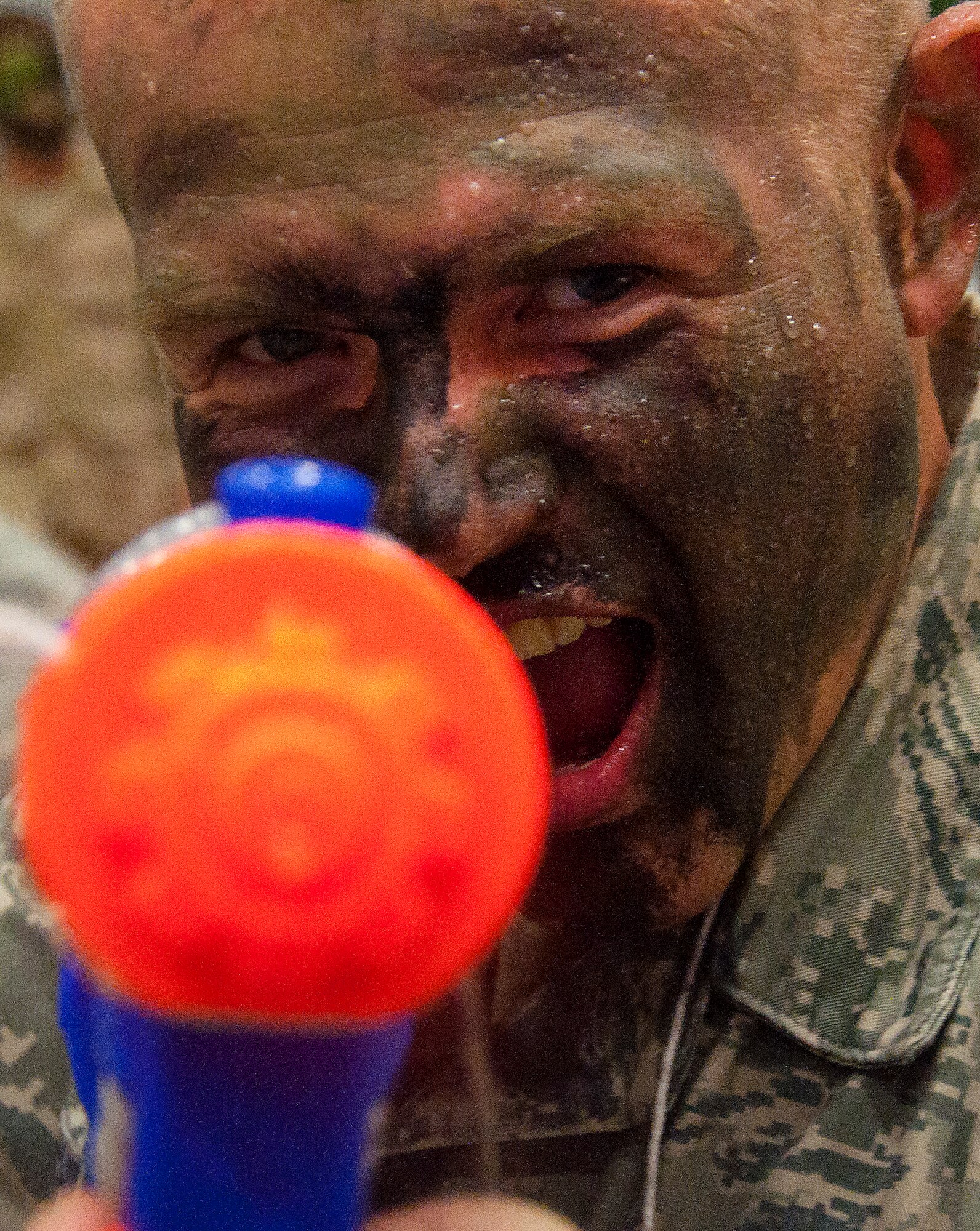 130913-F-GZ967-161 Senior Airman Justin Schuetz, 90th Civil Engineer Squadron, takes aim as he prepares to return fire during a water war. The water war was part of an enlisted combat dining in hosted in the Peacekeeper High Bay, Bldg. 1501, Sept. 13, 2013. (U.S. Air Force photo by Airman 1st Class Brandon Valle)