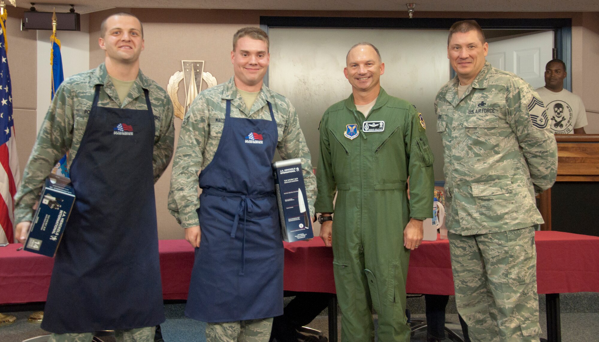 130913-F-GZ967-058 Col. Donnie Holloway, 90th Operations Group commander, and Chief Master Sgt. James Dye, 90th Operations Group chief enlisted manager, presents Airman 1st Class Brian Macomber and Senior Airman Kevin Pordon, 321st Missile Squadron missile chefs, with set of cooking knives after the chefs won a the F.E. Warren Air Force Base, Wyo., missile top chef competition Sept. 13, 2013. (U.S. Air Force photo by Airman 1st Class Brandon Valle)