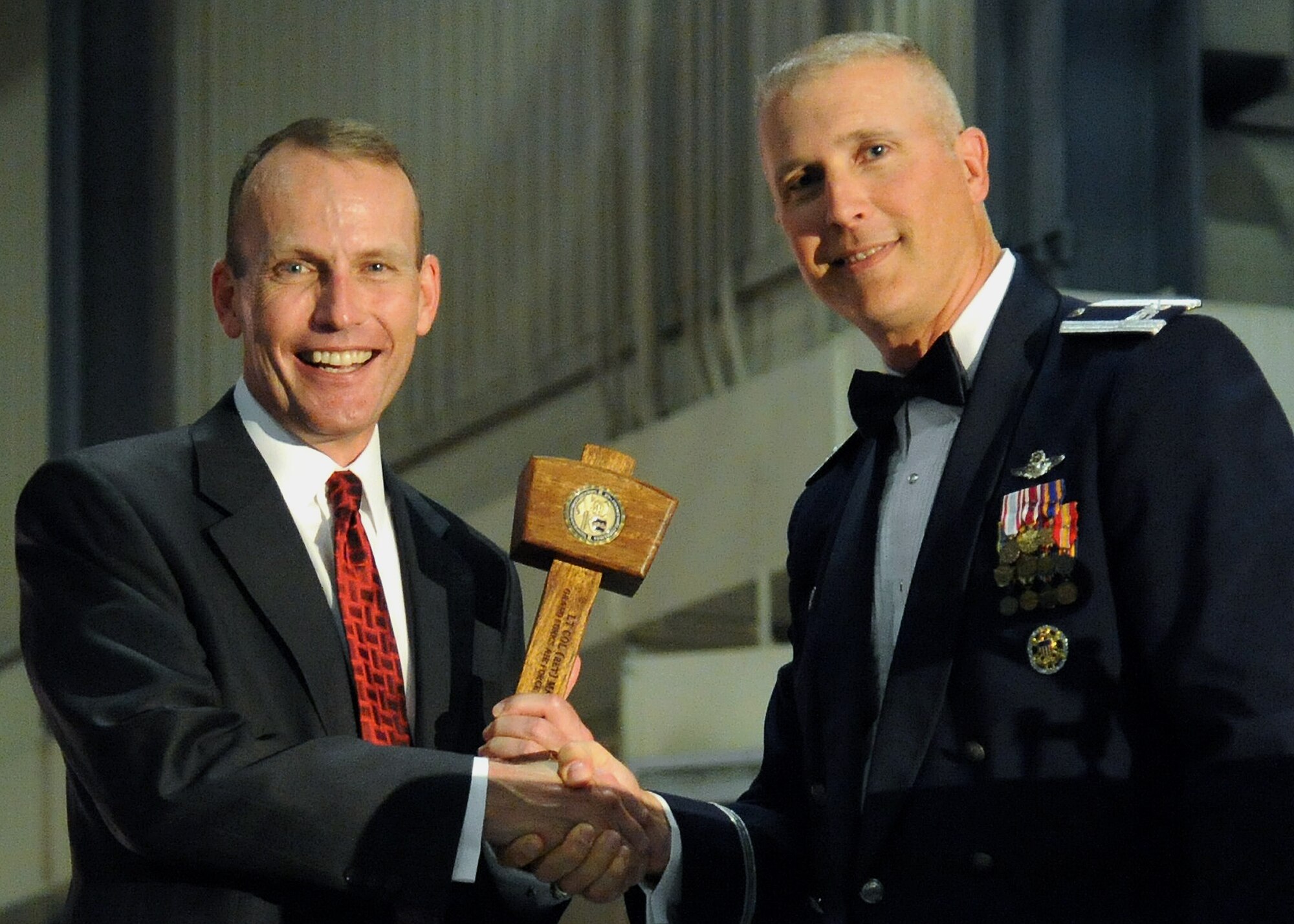Col. Paul Bauman, 319th Air Base Wing commander,  presents Lt. Col. retired Mark Schaible with a memento after his speech at the 2013 Air Force Ball, Sept. 13, 2013 on Grand Forks Air Force Base, N.D. Schaible speaks to groups everywhere about his experiences to give hope to others facing challenges. (U.S. Air Force photo/Airman 1st Class Zachiah A. Roberson)