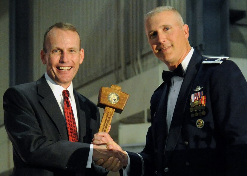 Col. Paul Bauman, 319th Air Base Wing commander,  presents Lt. Col. retired Mark Schaible with a memento after his speech at the 2013 Air Force Ball, Sept. 13, 2013 on Grand Forks Air Force Base, N.D. Schaible speaks to groups everywhere about his experiences to give hope to others facing challenges. (U.S. Air Force photo/Airman 1st Class Zachiah A. Roberson)