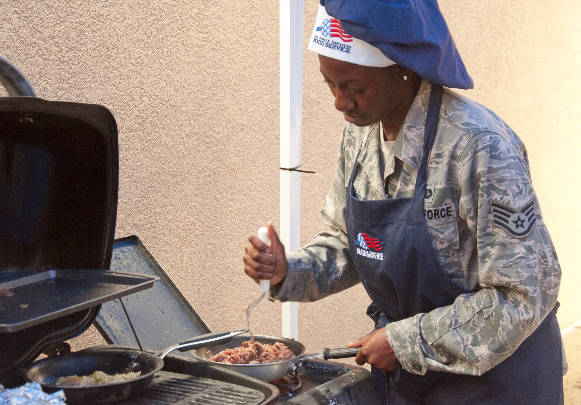 130913-F-GZ967-006 Staff Sgt. Britney Robinson, 320th Missile Squadron missile chef, prepares her version of steak and eggs during a top chef competition Sept. 13, 2013. The competition between the missile chefs from the F.E. Warren Air Force Base, Wyo., 319th, 320th, and 321st Missile squadrons heated up as the teams not only competed with each other, but had to battle heavy wind and rain as well. (U.S. Air Force photo by Airman 1st Class Brandon Valle)