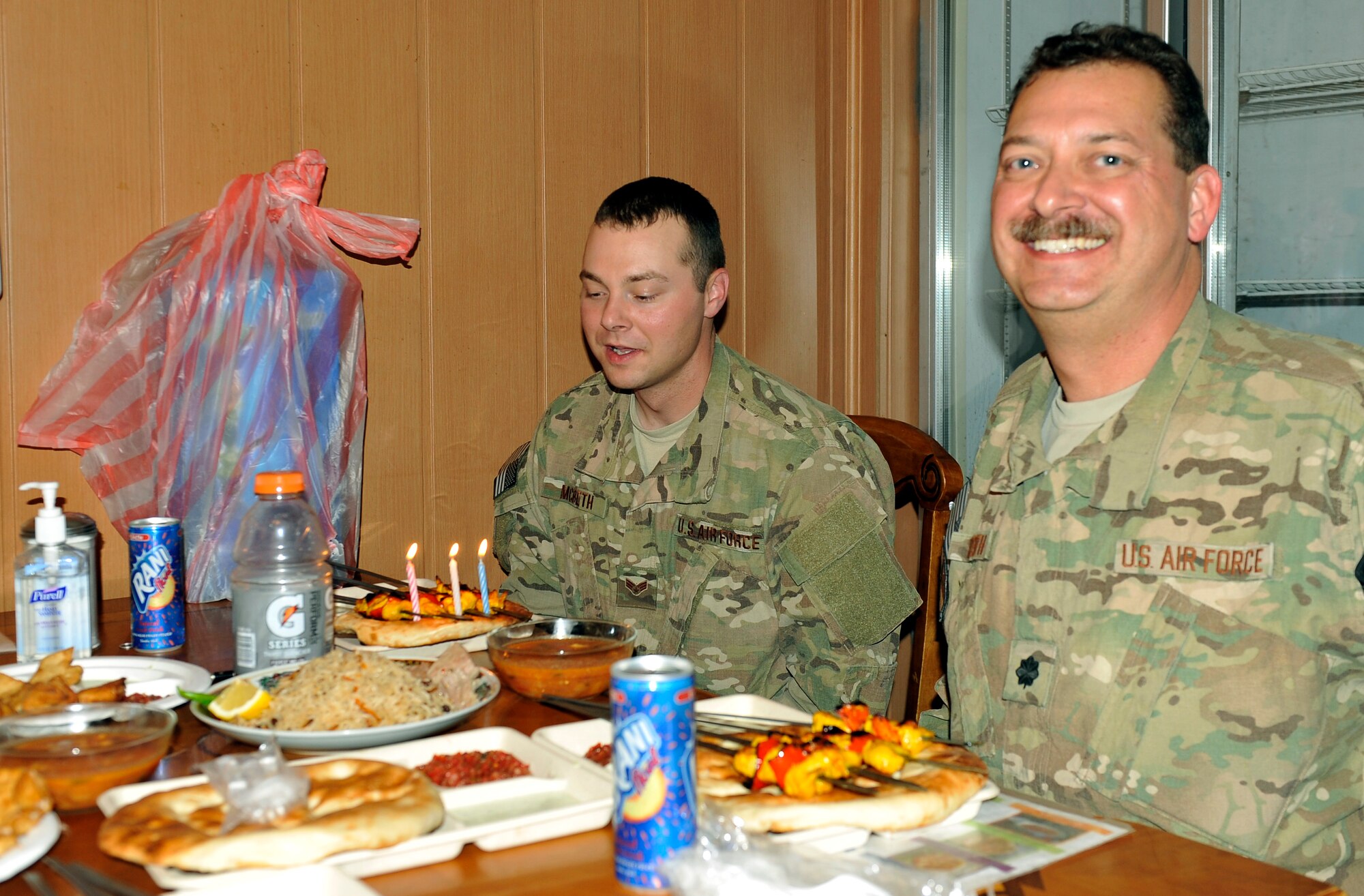 Lt. Col. Jonathon McBeth and his son, Senior Airman Jonathan McBeth, share a birthday meal together on Bagram Airfield, Afghanistan, Sept. 17, 2013. 