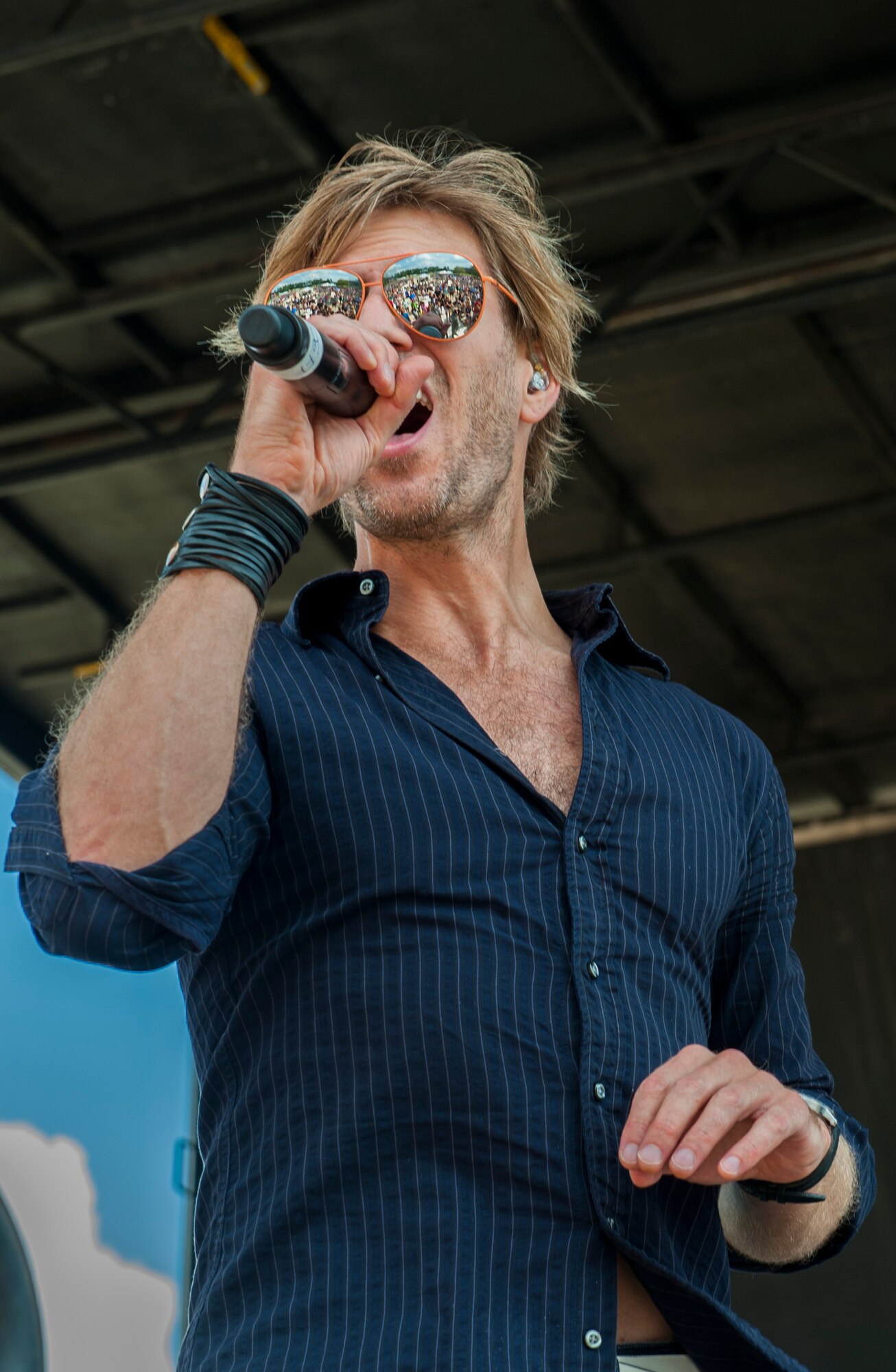 Jeff Vezain, vocalist for the Lt. Dan Band, sings at Moody Air Force Base, Ga., Sept. 15, 2013. The band helps raise money for military members and their families who have been injured or did not make it home. (U.S. Air Force photo by Airman Alexis Grotz/Released)