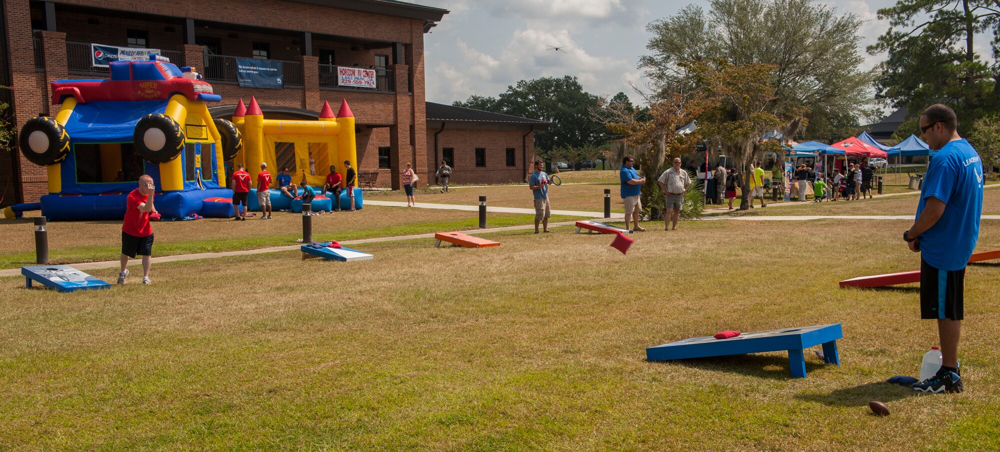 Airmen and family members take part in games and food at Moody Air Force Base, Ga., Sept. 15, 2013. The base coordinated a day full of events leading to a concert by the Lt. Dan Band. (U.S. Air Force photo by Airman Alexis Grotz/Released)