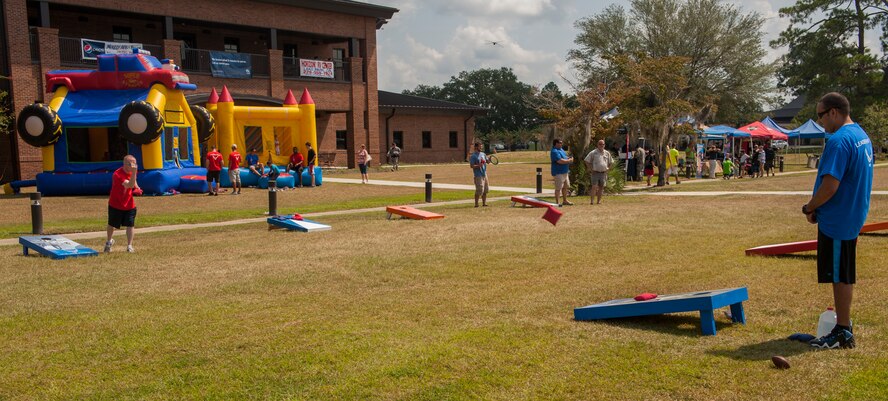 Airmen and family members take part in games and food at Moody Air Force Base, Ga., Sept. 15, 2013. The base coordinated a day full of events leading to a concert by the Lt. Dan Band. (U.S. Air Force photo by Airman Alexis Grotz/Released)