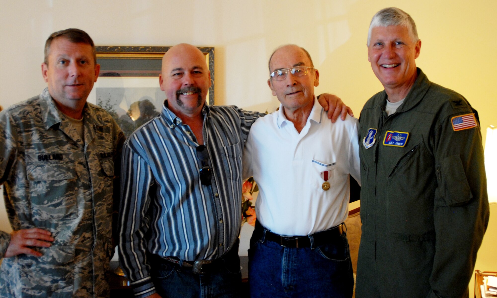 HOMEWOOD, Ala. -- Col. Cliff James, the 117 ARW Commander, and Command Chief Master Sgt. David Bullard presents World War II veteran Army Cpl. Andre Vanbrabant his service medals here on Saturday after they could not be found. (U.S. Air National Guard photo by Maj. Lisa Weaver/Released)