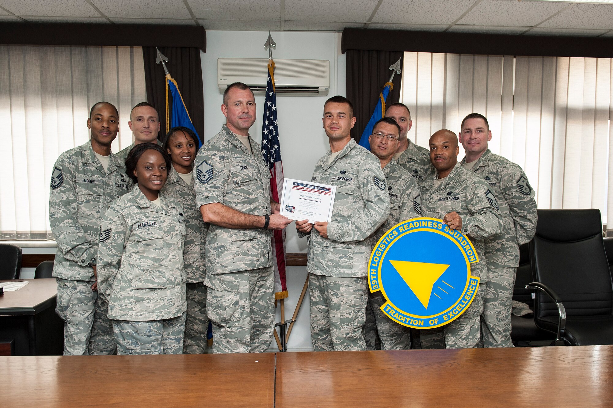 Staff Sgt. Timothy Wiseman, 39th Logistics Readiness Squadron fuels hydrant supervisor, receives the Unsung Hero Award from the Incirlik Top 3 organization Sept. 17, 2013, at Incirlik Air Base, Turkey.  The Top 3 presents the Unsung Hero Award monthly to an Airman who demonstrates superior job performance and exceptional leadership. (U.S. Air Force photo by Airman 1st Class Nicole Sikorski/Released)
