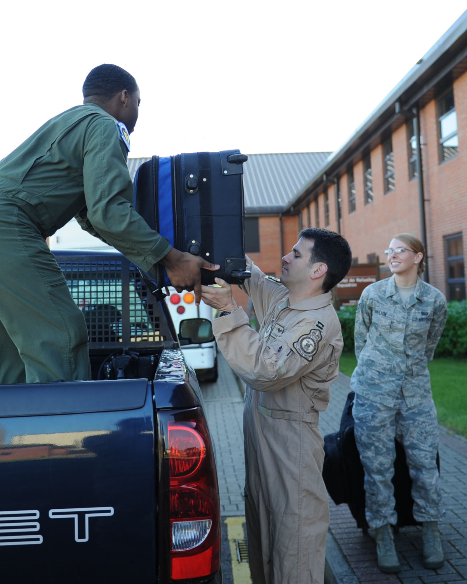 Team Mildenhall Airmen load bags onto a truck to be taken to the flightline Sept. 16, 2013, on RAF Mildenhall, England. The Airmen deployed to Moron Air Base, Spain, where the 351st Expeditionary Air Refueling Squadron continues to provide aerial-refueling support to French fighter aircraft operating over Mali. (U.S. Air Force photo by Airman 1st Class Preston Webb/Released)