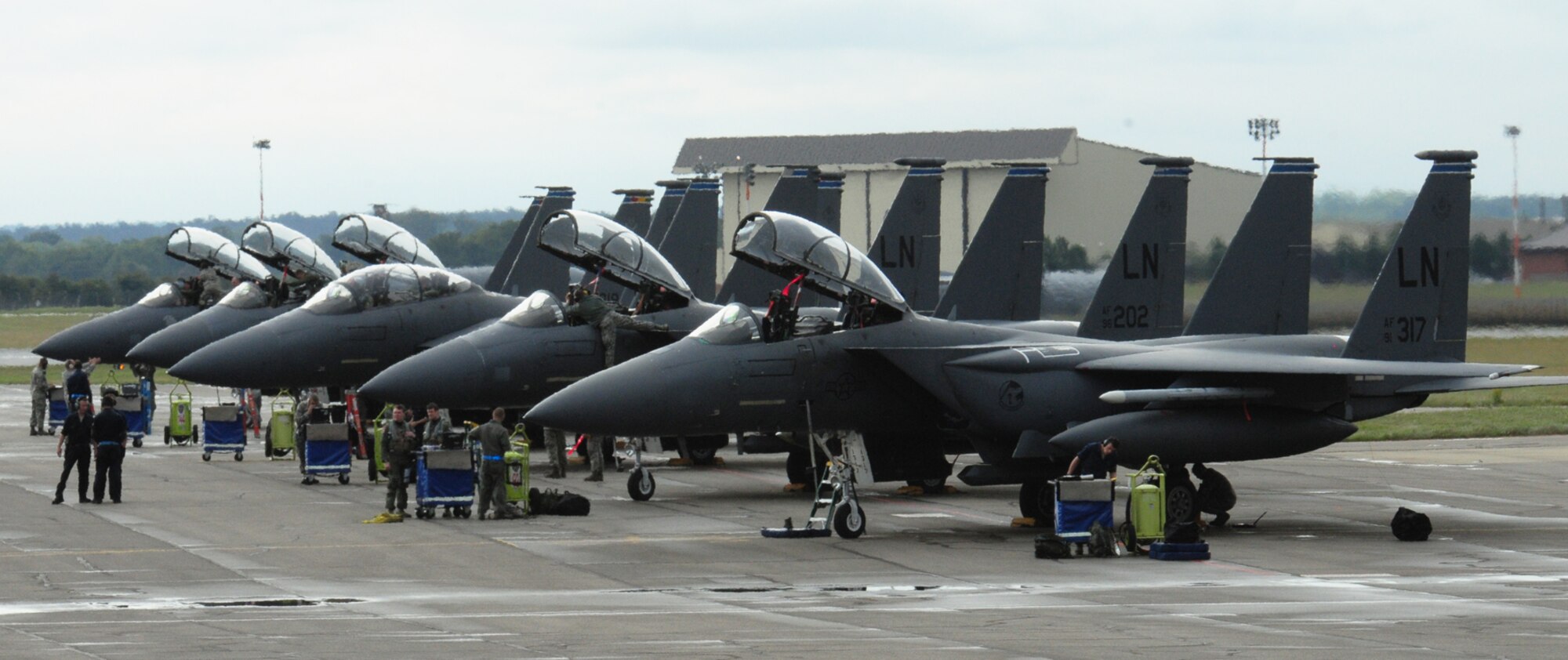The first wave of RAF Lakenheath-based F-15s line up on a hardstand Sept. 13, 2013, after flying into RAF Mildenhall, England. Approximately 10 F-15s are being temporarily housed here while runway repairs are completed at their home station. The normal quiet hours for RAF Mildenhall will apply to the F-15 aircraft, which means unless waivers are granted for specific occasions, there will be no F-15s flying weeknights between 11 p.m. and 6 a.m., and no flying during weekends between 6 p.m. Friday through 6 a.m. Monday. (U.S. Air Force photo by Karen Abeyasekere/Released)