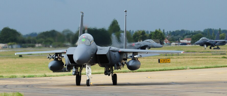 Fighter jets from RAF Lakenheath taxi towards their parking spots Sept. 13, 2013, as the first wave of jets fly into RAF Mildenhall, England. Approximately 10 F-15s are being temporarily housed here while runway repairs are completed at their home station. The normal quiet hours for RAF Mildenhall will apply to the F-15 aircraft, which means unless waivers are granted for specific occasions, there will be no F-15s flying weeknights between 11 p.m. and 6 a.m., and no flying during weekends between 6 p.m. Friday through 6 a.m. Monday. (U.S. Air Force photo by Karen Abeyasekere/Released)