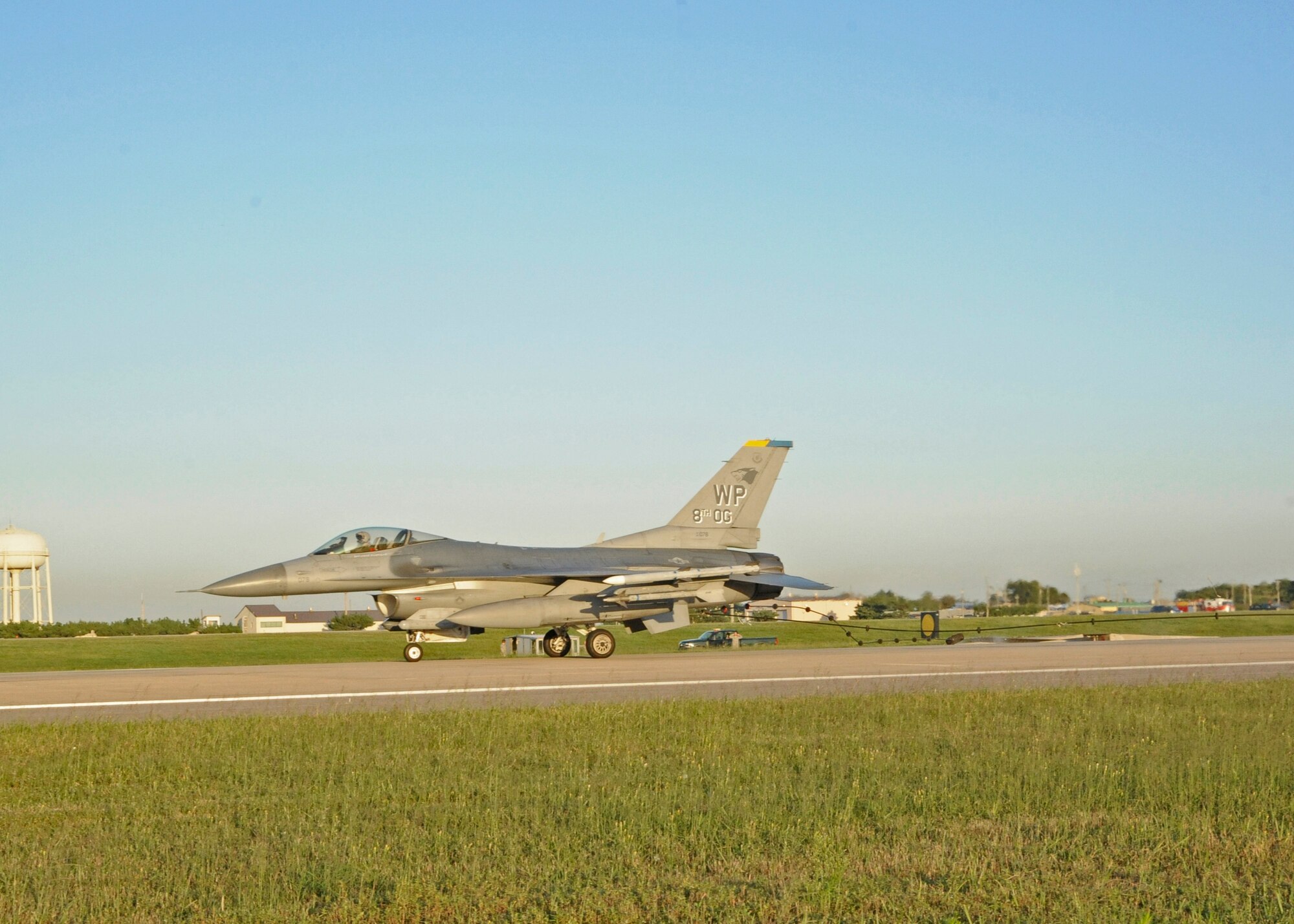 An F-16 Fighting Falcon speeds over the new Barrier Arresting Kit-12 barrier at Kunsan Air Base, Republic of Korea, Sept. 17, 2013. The jet simulated an in-flight emergency in order to certify, or test, the barrier and ensure proper functionality. (U.S. Air Force photo by Staff Sgt. Jessica Haas/Released)