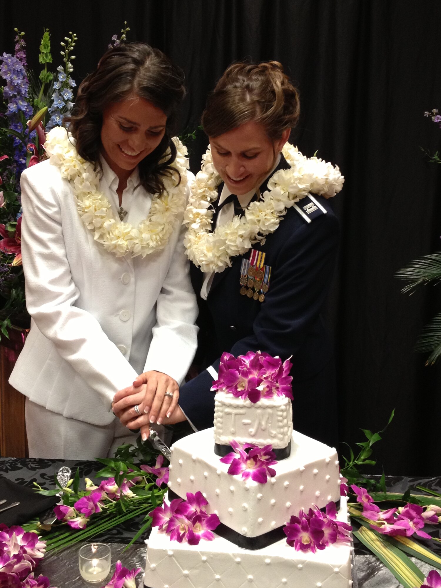 Dana McCown, retired lieutenant colonel, and Capt. Dawn Tanner, 51st Medical Operations Squadron Family Advocacy element leader, cut their wedding cake in Omaha, Neb., May 3, 2013. As a same-sex couple, Tanner and McCown both made sacrifices during their careers in order to stay together and are excited for the next generation of service members who won’t have to make the same hard choices. (U.S. Air Force Courtesy Photo/Capt. Dawn Tanner)