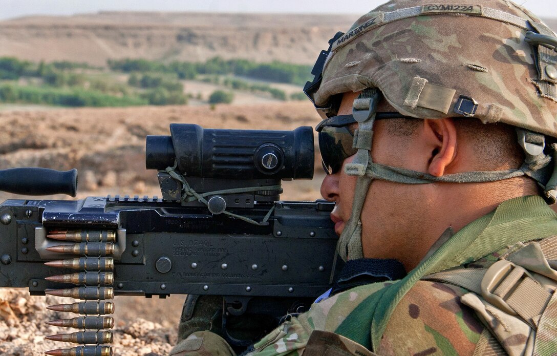 U.S. Army Pfc. Richard Martinez scans the area using his machine gun's optic lens while providing security during a reconnaissance mission in a village south of Forward Operating Base Fenty in Afghanistan's Nangarhar province, Sept. 8, 2013. Martinez is assigned to the 1st Cavalry Division's 4th Squadron, 9th Cavalry Regiment, 2nd Armored Brigade Combat Team.