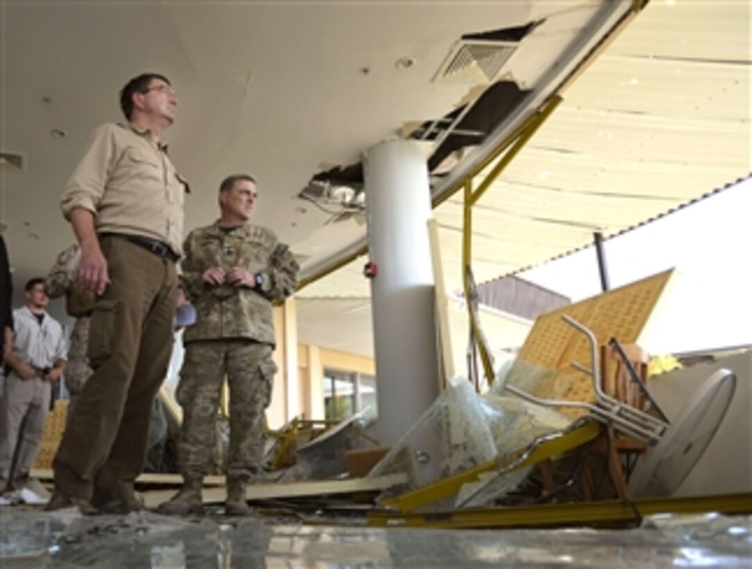 Deputy Secretary of Defense Ashton B. Carter, center, and Lt. Gen. Mark Milley, right, look over the blast damage to the U.S. Consulate in Herat, Afghanistan, on Sept. 14, 2013.  Armed Taliban fighters and a vehicle bomb killed two Afghan police officers and a security guard in the assault on the consulate on Sept. 13th.  Carter is on a weeklong trip to Afghanistan, Pakistan and India to meet with senior leaders and troops deployed to the region.  