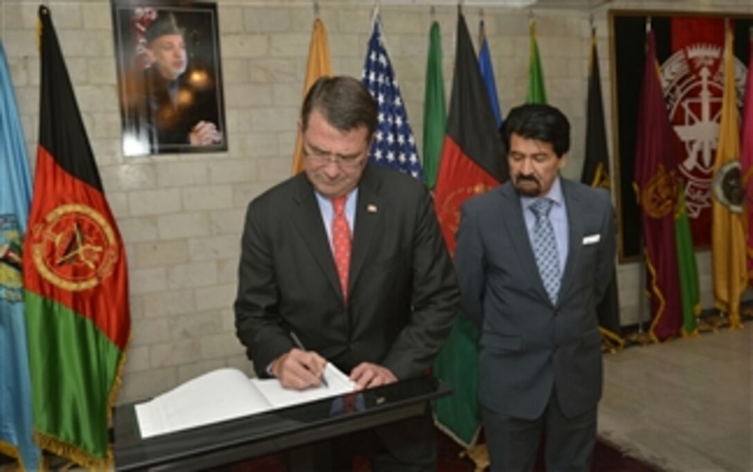 Afghan Deputy Minister of Defense Zaher Azimi, right, watches as Deputy Secretary of Defense Ashton B. Carter signs the guestbook at the Afghanistan Ministry of Defense in Kabul, Afghanistan, on Sept. 14, 2013.  Carter is on a weeklong trip to Afghanistan, Pakistan and India to meet with senior leaders and troops deployed to the region.  