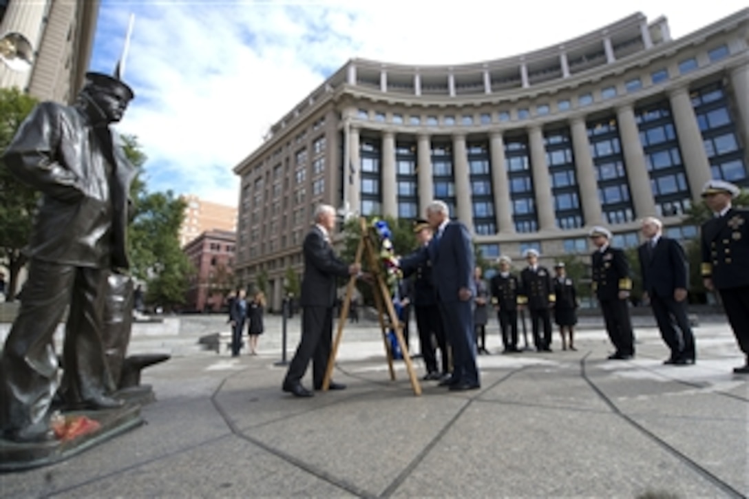 Secretary of Defense Chuck Hagel, right, and Chairman of the Joint Chiefs of Staff Gen. Martin Dempsey place a wreath at the Navy Memorial in Washington, D.C., on Sept. 17, 2013.  The two defense leaders held the small ceremony to remember the 12 victims of the Navy Yard shooting that took place the day prior.  The wreath was placed adjacent to The Lone Sailor statue, which represents "all people who have ever served, are serving now, or are yet to serve in the United States Naval services".  