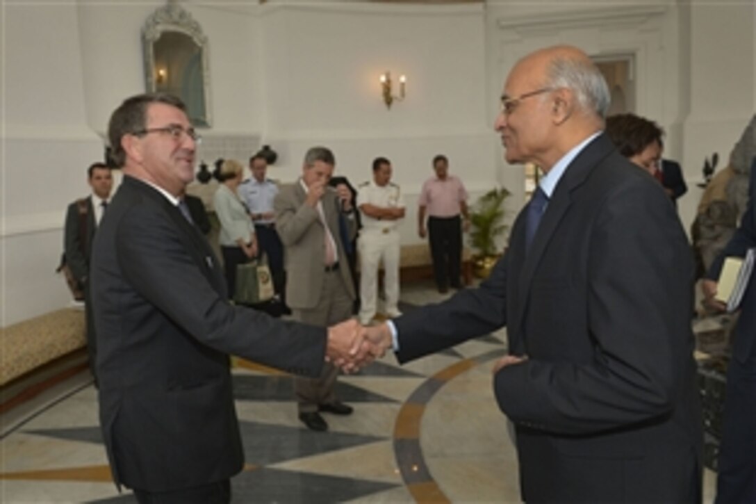 U.S. Deputy Defense Secretary Ash Carter, left, is welcomed by Indian National Security Advisor Shivshankar Menon at Hyderabad House in New Delhi, Sept. 17, 2013.