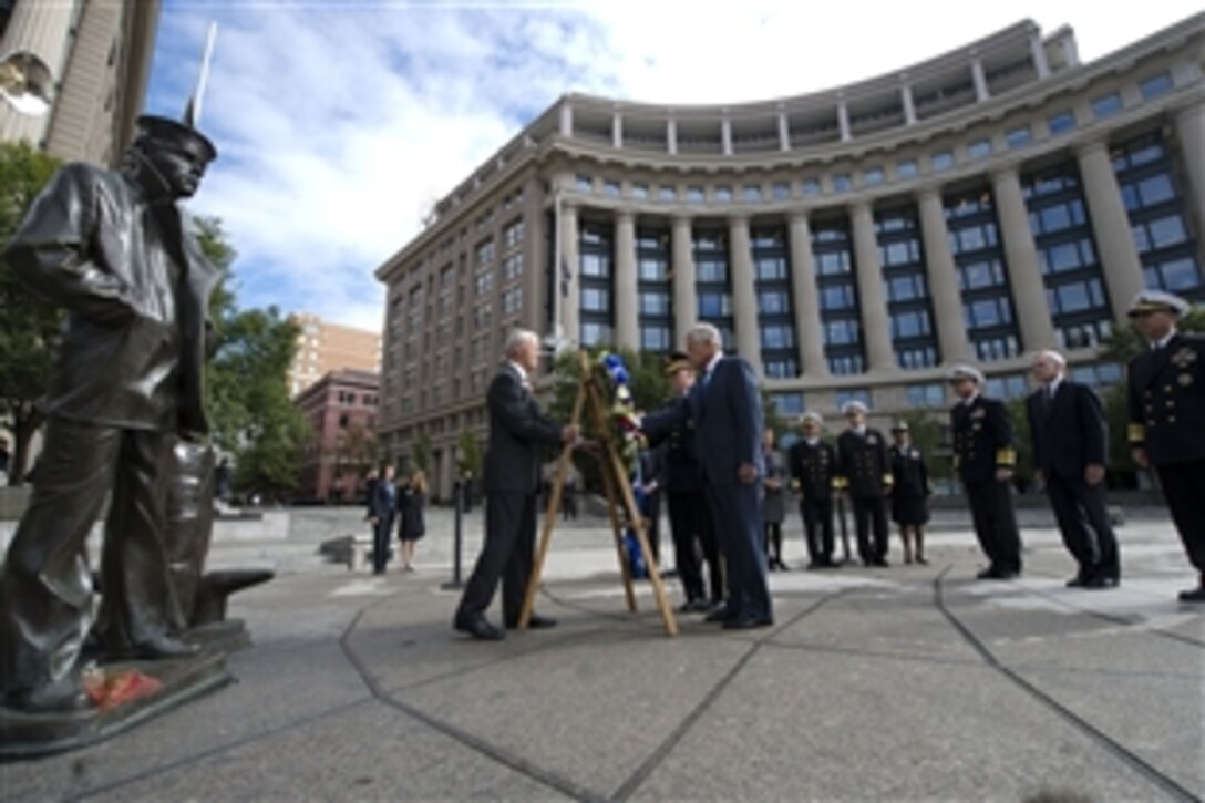 Defense Secretary Chuck Hagel, center, and Army Gen. Martin E. Dempsey, chairman of the Joint Chiefs of Staff, lay a wreath at the Navy Memorial in Washington, D.C., Sept. 17, 2013. The defense leaders held the small ceremony to remember the 12 victims of the Sept. 16 shooting at the Washington Navy Yard. Navy Secretary Ray Mabus, second from right, looks on.