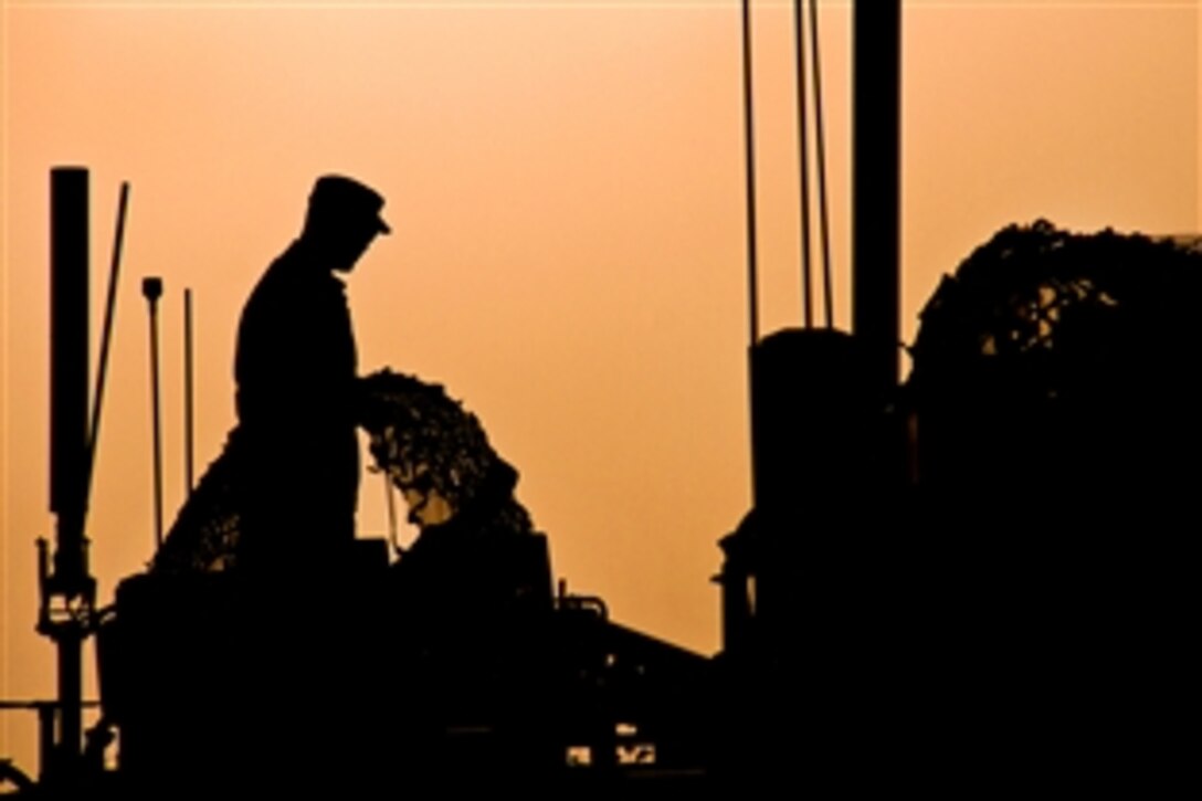 A U.S. soldier preps a military tactical vehicle as the sun sets before moving out on a mission on Combat Outpost Zormat, Afghanistan, Sept. 9, 2013. The soldier is assigned to the 101st Airborne Division's Company D, 1st Battalion, 506ht Infantry Regiment, 4th Brigade Combat Team.