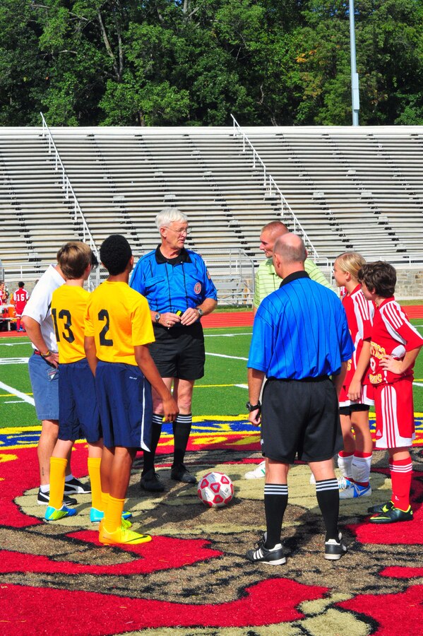 Referees, coaches and team captains meet before a middle school soccer game between Highland School, from Warrenton, and Quantico Middle/High School at Butler Stadium on Sept. 17, 2013. Highland won the game 7-1. 