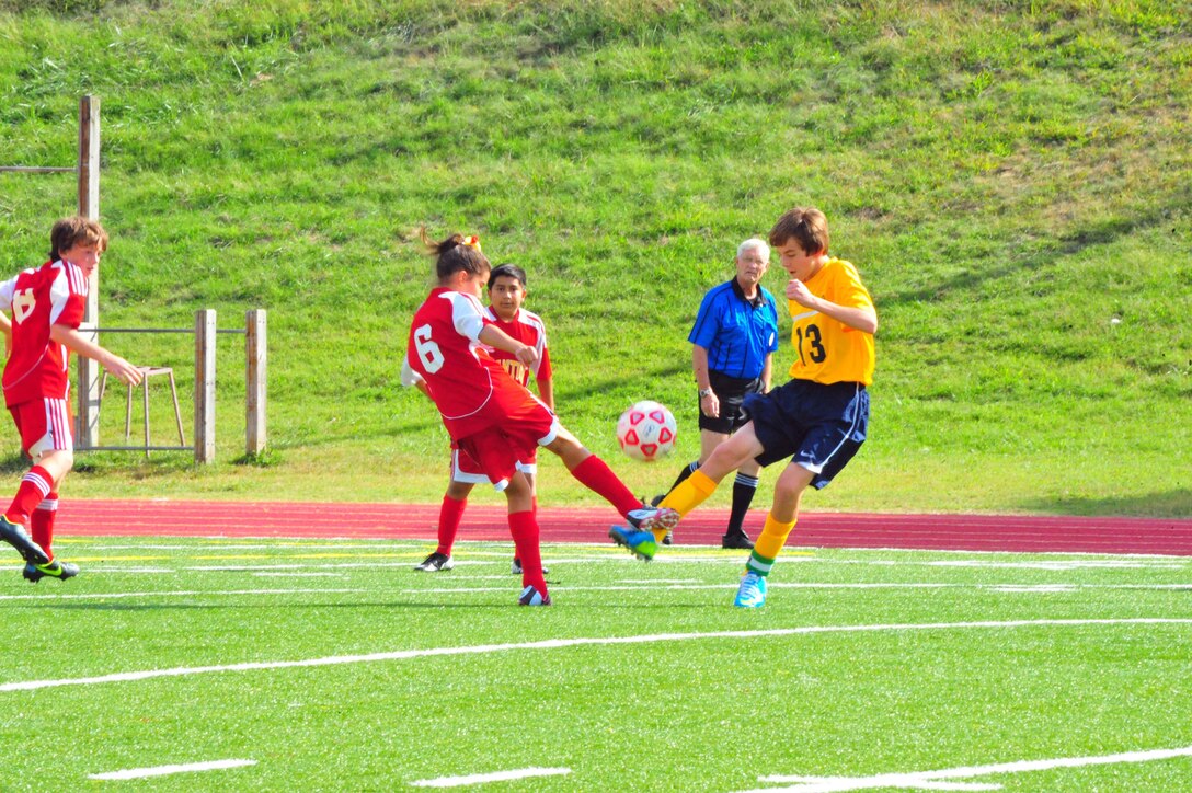 Soccer players fight over a ball during a middle school soccer game between Highland School, from Warrenton, and Quantico Middle/High School at Butler Stadium on Sept. 17, 2013. Quantico scored their first goal of the season during their second home game. 