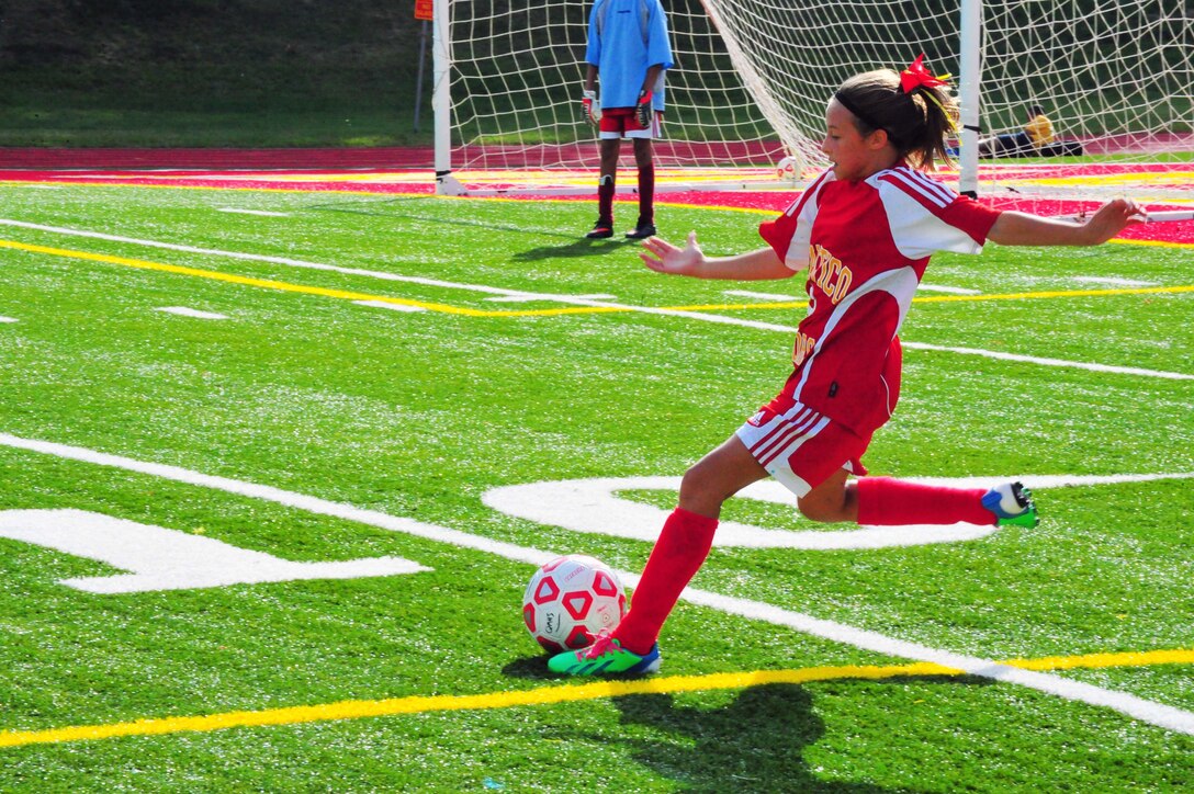 Ava, 11, kicks a ball during a middle school soccer game between Highland School, from Warrenton, and Quantico Middle/High School at Butler Stadium on Sept. 17, 2013. Highland won the game 7-1. 