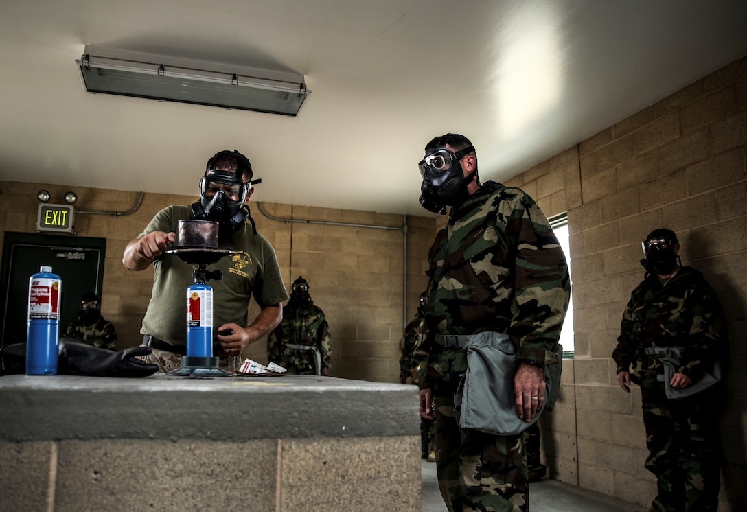 Staff Sgt. Nicholas G. Bibby, chemical, biological, radiological and nuclear chief, Marine Aircraft Group 39, prepares to release CS gas over a burner during the 15th Marine Expeditionary Unit’s CBRN defense mask confidence training at Camp Margarita aboard Camp Pendleton, Calif., Sept. 17. Bibby, 30, is from Los Angeles. (U.S. Marine Corps photo by Cpl. Emmanuel Ramos/Released)