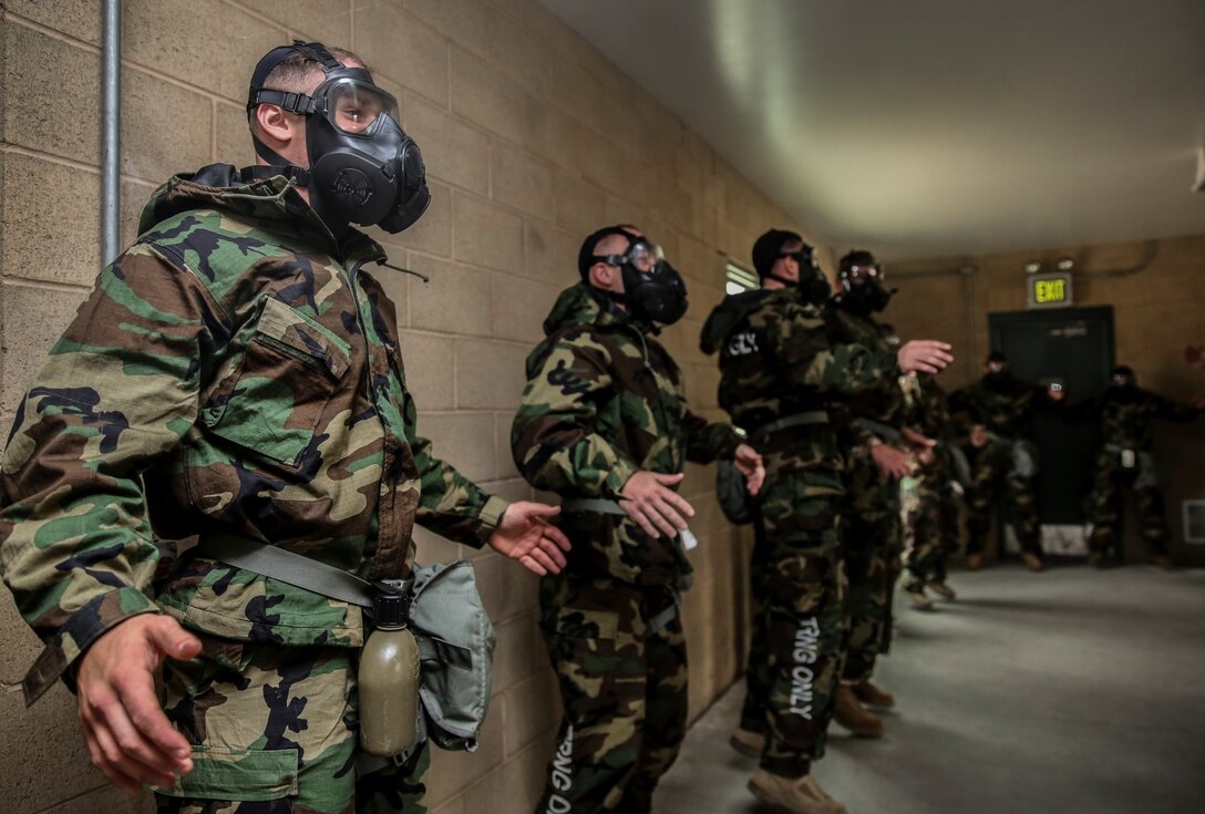 Marines with the 15th Marine Expeditionary Unit conduct side straddle hops to increase their heart rates during their unit’s chemical, biological, radiological and nuclear defense mask confidence training at Camp Margarita aboard Camp Pendleton, Calif., Sept. 17. (U.S. Marine Corps photo by Cpl. Emmanuel Ramos/Released)