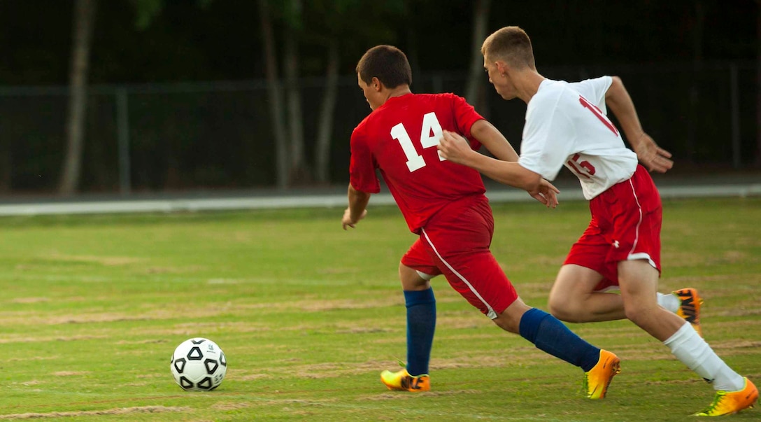 John Cooling, sophomore soccer player for the Lejeune Devilpups, attempts to reach the soccer ball before his opponent during a varsity soccer match against the Pender Patriots aboard Marine Corps Base Camp Lejeune, Sept. 12.