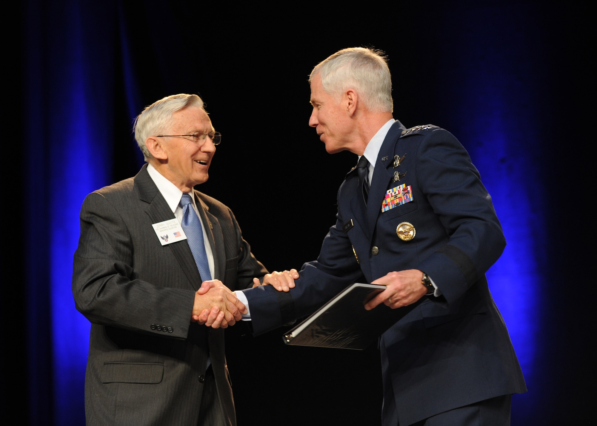 Jerry White presents Gen. William L. Shelton a book on behalf of the Air Force Association Sept. 17, 2013, at the Air Force Association’s 2013 Air & Space Conference and Technology Exposition in Washington, D.C. The conference is a professional development event sponsored and conducted by AFA in support of the total Air Force. White is the vice chairman of the board and Shelton is the commander of Air Force Space Command. (U.S. Air Force photo/Airman 1st Class Aaron Stout)