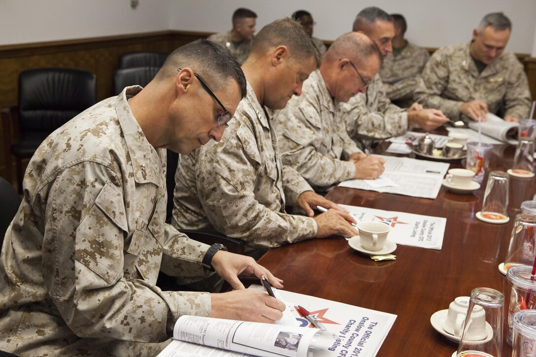 Brig. Gen. Robert F. Castellvi, commanding general of Marine Corps Installations East, along with other senior leaders, signs his pledge for the Combined Federal Campaign aboard Marine Corps Base Camp Lejeune, Sept. 10. The campaign is an annual fundraising drive providing federal civilian and military employees the opportunity to donate to local, national, and international non-profit organizations. Contributions can be made online via MyPay or through a unit representative. For more information, contact Alicia Hill at 449-9703 or visit onslowcountycfc.org.