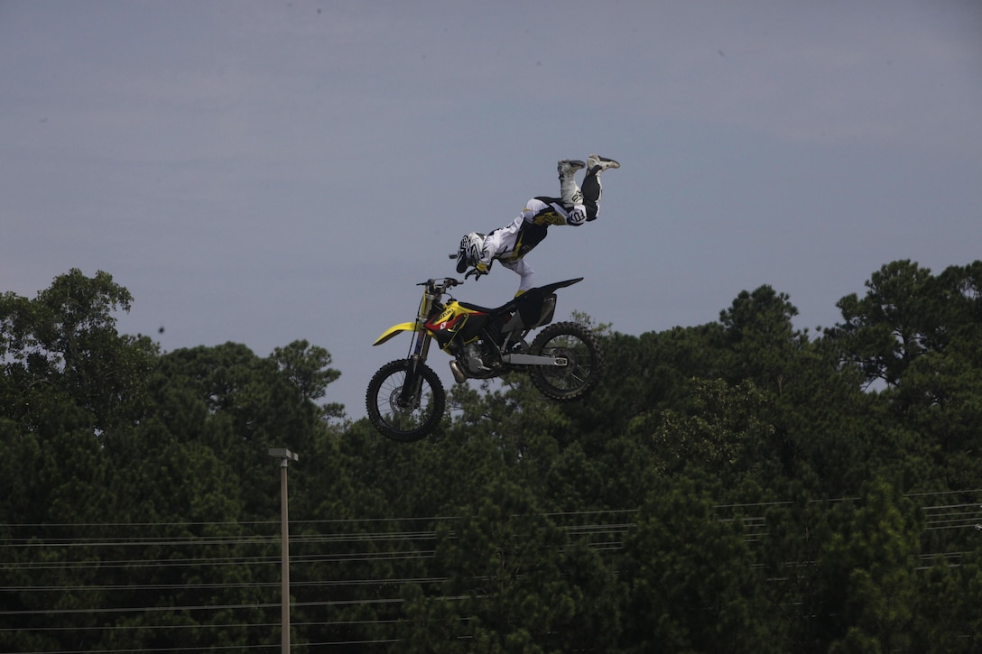 Dustin Miller, freestyle motocross rider, performs a superman seat grab trick for service members and families during an event held at the Marine Corps Exchange aboard Marine Corps Base Camp Lejeune, Friday.