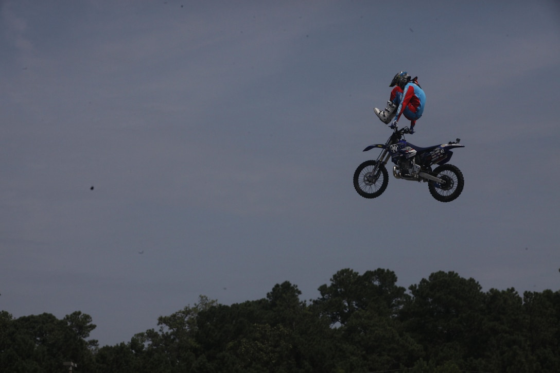 Jeff Griffin, freestyle motocross rider, performs a sterilizer trick for fans during an event hosted at the Marine Corps Exchange aboard Marine Corps Base Camp Lejeune, Friday. More than 500 spectators gathered for the motocross event.