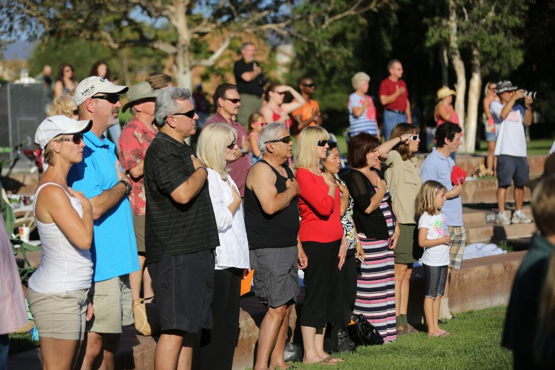 Residents of Rancho Santa Margarita sing the national anthem during an annual Patriots' Day event here, Sept. 15, 2013. More than 125 Marines of the city's adopted 2nd Battalion, 5th Marine Regiment, were onhand to showcase Marine Corps equipment and life in the military. The event honored military veterans and the lives lost in the wake of Sept. 11.