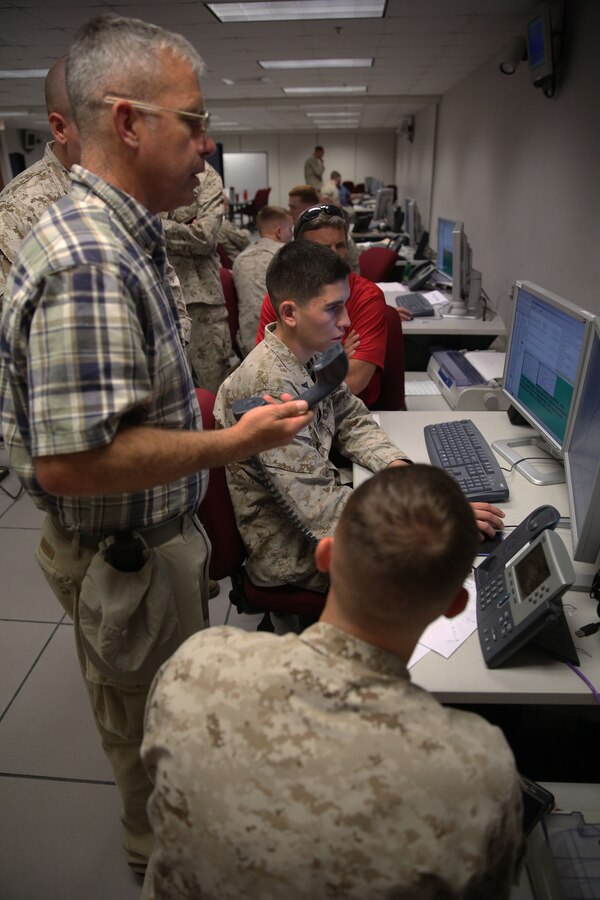 Marines with 6th Marine Regiment, 2nd Marine Division, work with II Marine Expeditionary Force Simulation Center civilian personnel to properly use the center’s computers as part of a training command post exercise aboard Marine Corps Base Camp Lejeune Sept. 18, 2013. The simulation center allows regiments to fight an enemy without having to execute a regimental-sized field operation. Civilian personnel who work at the center created an intelligent, computerized enemy with the specifications the regiment wanted to create a realistic situation and provided technical aid to the Marines when it came to using the computers in order to move units. 