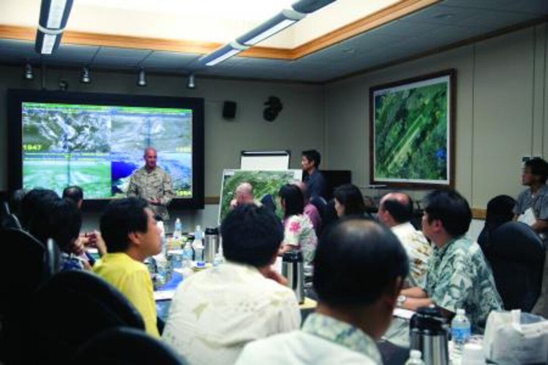 Lt. Col. Sean P. Patak, center left, speaks to a delegation of the Liberal Democratic Party of Japan Sept. 9 at Marine Corps Air Station Futenma. The delegation visited the air station to learn more about the air station’s capabilities and the MV-22B Osprey. Patak is the executive officer of MCAS Futenma. Photo by Lance Cpl. Natalie M. Rostran